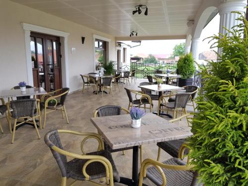 un patio vide avec des tables et des chaises dans un restaurant dans l'établissement Equinoxe Royal Reghin, à Reghin
