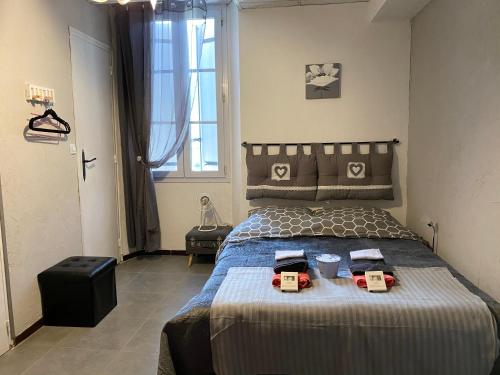 a bedroom with a bed with two boxes on it at La Cigale in Annot