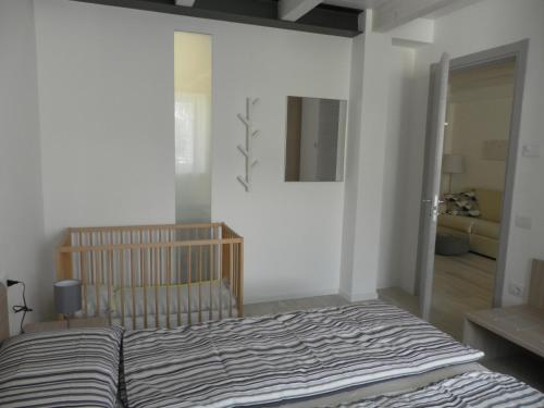 a bedroom with a striped bed in a room at La casa di Virginia in Arco
