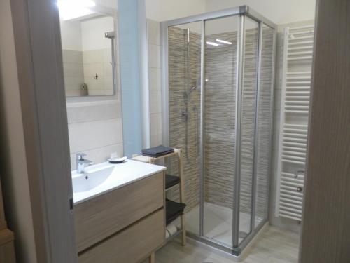 a bathroom with a sink and a glass shower at La casa di Virginia in Arco