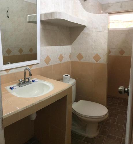 a bathroom with a sink and a toilet at Bungalows El Rincon de La Riviera in Rincon de Guayabitos