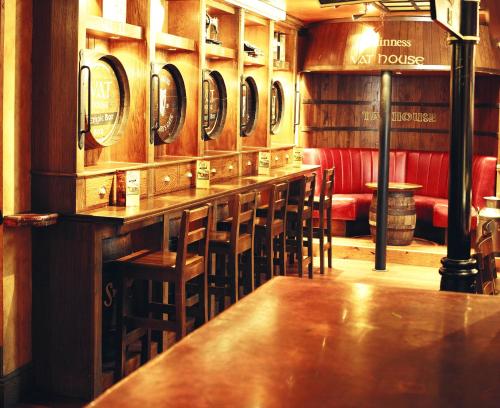 a bar in a restaurant with a row of mirrors at Blooms Hotel in Dublin