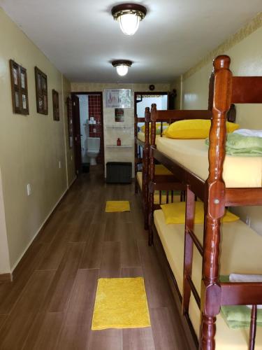 a hallway with bunk beds in a dorm room at Paz e Amor Suite in Abraão