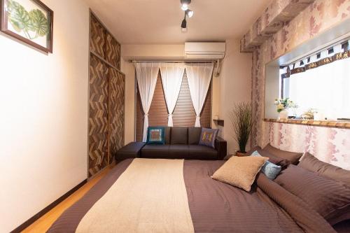 Tempat tidur dalam kamar di Omotenashi House Kawaguchi