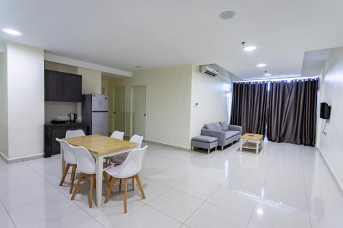a kitchen and a dining room with a table and chairs at Emart Hotel (Riam) in Miri