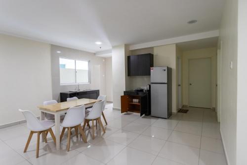a kitchen with a table and chairs and a refrigerator at Emart Hotel (Riam) in Miri