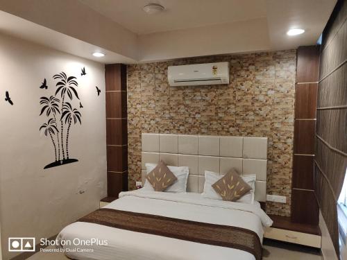 a bedroom with a bed and a brick wall at Starlit Select Nirvana in Varanasi