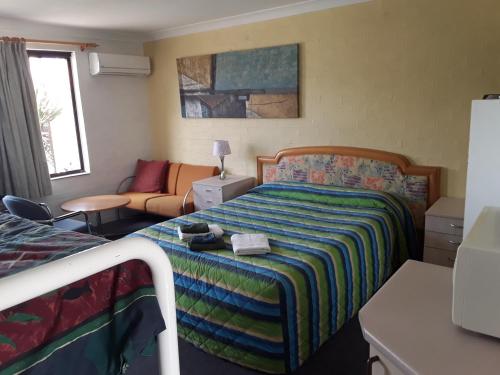 Postel nebo postele na pokoji v ubytování Snowdream Motel