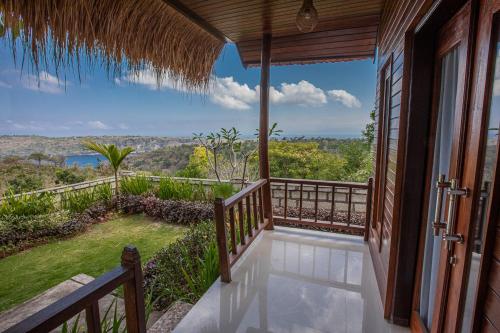 a balcony of a house with a view at Abian Selumbung Bungalow in Nusa Penida