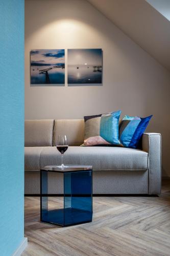 a living room with a couch and a glass table at Hotel Felix in Zürich