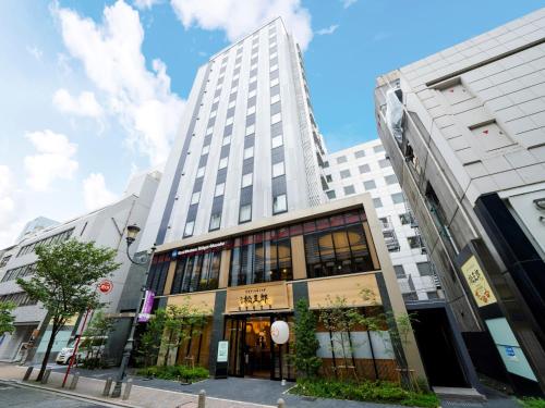a tall white building on a city street at Best Western Hotel Fino Tokyo Akasaka in Tokyo