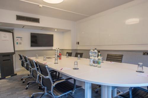 a conference room with a large white table and chairs at Crowne Plaza - Sheffield by IHG in Sheffield