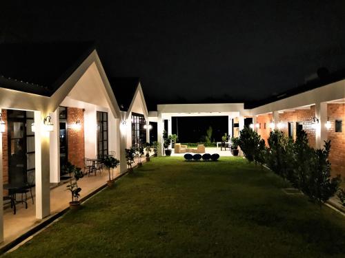 a house with a lawn at night at The Rubber Escape, Melaka in Melaka
