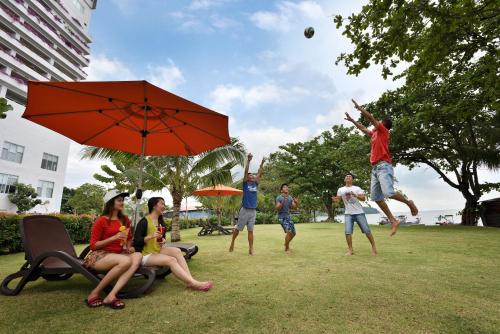a group of people playing with a ball in a park at Lexis Suites Penang in Bayan Lepas