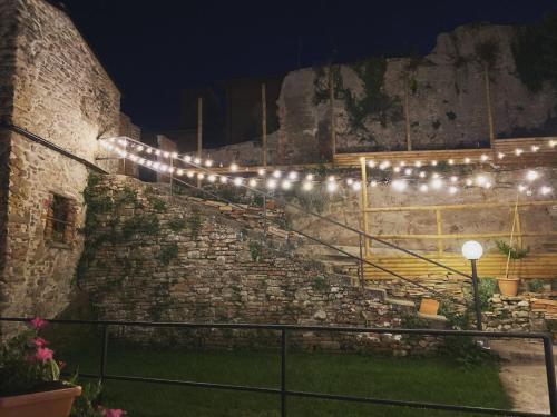 a group of lights on a stone wall at night at Il Cavalier Veggiani B&B in Mercato Saraceno