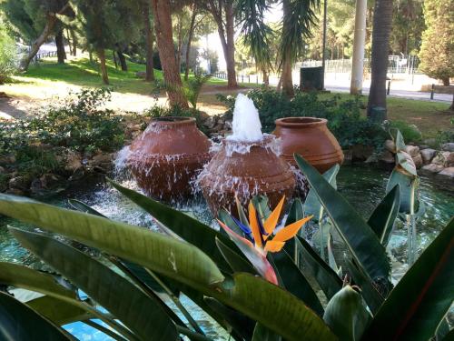 two large vases in a fountain in a park at A1 Elegant Vouliagmeni apt in a Unique Spot in Athens
