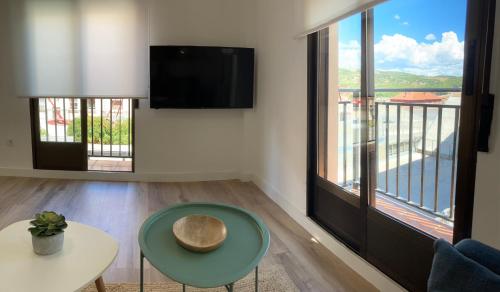 a living room with a view of a balcony at TeruelHOME I Con Encanto y parking in Teruel