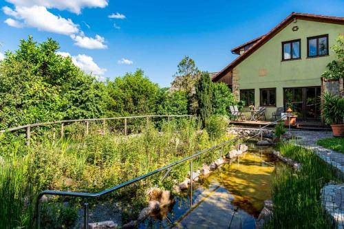 a house with a pond in front of it at Landhotel Gut Wildberg mit Sauna in Meißen