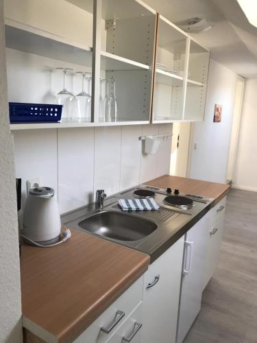 a kitchen with a sink and a counter top at Wohnen am Wanderweg II in Aurich