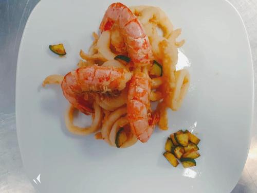 a shrimp with pasta on a white plate at Bed&Belvedere in Otranto