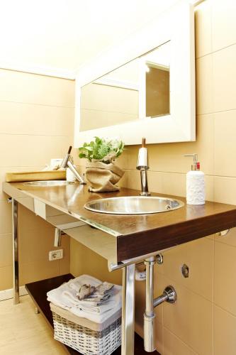a bathroom with a sink and a mirror at Petite Suite in Bergamo