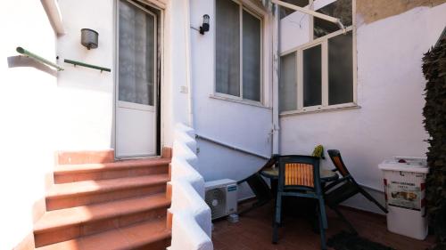 a porch with a chair next to a house at Royal Dante in Naples