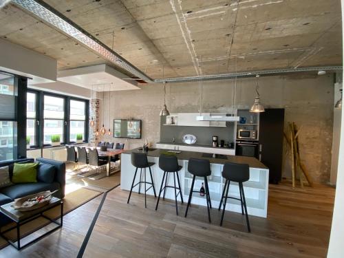 a kitchen and living room with a couch and a table at Luxus-Loft-Sylt in Westerland (Sylt)