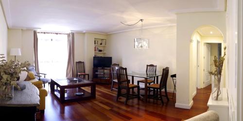 a living room with a table and chairs at estrada15 in Avila