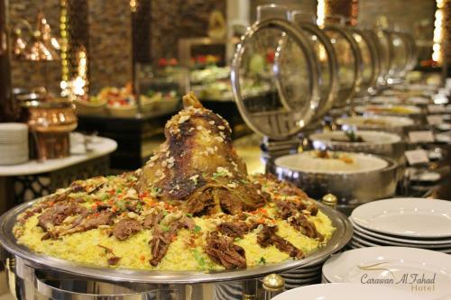 a buffet line of food on a table at Carawan Al Fahad Hotel in Riyadh
