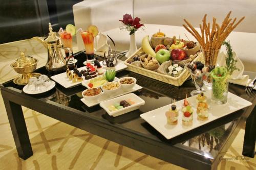 a table with a buffet of food on it at Carawan Al Fahad Hotel in Riyadh