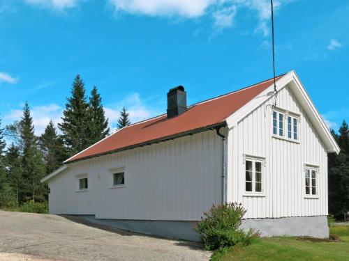 a white barn with a red roof at Holiday Home Øygårdsheia by Interhome in Grimstad