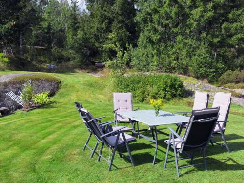 a table and chairs sitting on a lawn at Holiday Home Øygårdsheia - SOO615 by Interhome in Grimstad