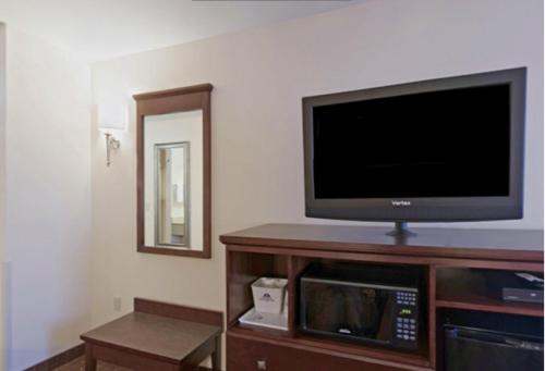 a flat screen tv sitting on top of a entertainment center at Americas Best Value Inn Saint Robert/Fort Leonard Wood in Saint Robert