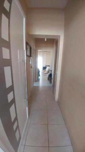 a hallway with a tile floor in a house at Christina Apartment in Derveni