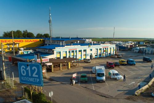 a parking lot with cars parked in front of a building at 612КМ in Stryi