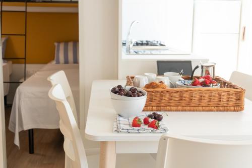 a table with a basket of fruit on a table at Campeggio Europa Silvella in San Felice del Benaco