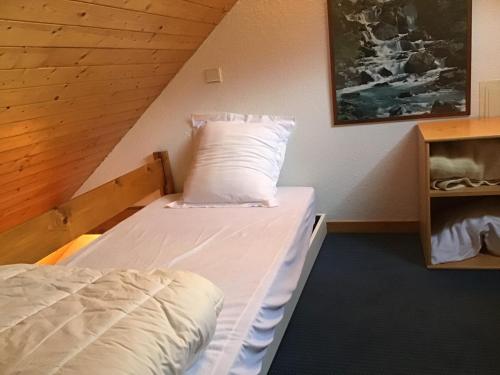 a bed in a room with a wooden ceiling at Tourmalet Home in Luz-Saint-Sauveur