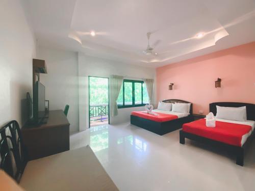 a room with two beds and a table and chairs at Aumpai Luxury in Lamai