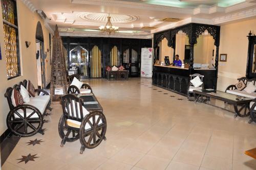a lobby with a bunch of horse drawn carriages at Golden Tulip Stone Town Boutique in Zanzibar City