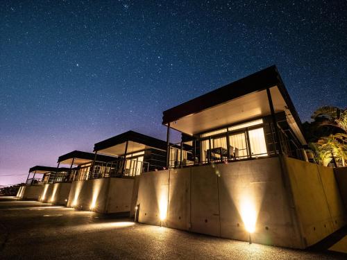 a building with lights on the side of it at night at One Suite THE TERRACE in Nakijin