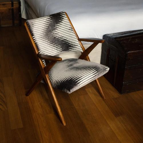 a black and white chair sitting on a wooden floor at Palazzo Albricci Peregrini in Como