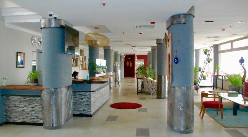 a lobby with blue columns in a building at Kiriri Garden Hotel in Bujumbura