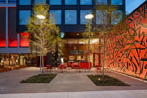 a building with tables and chairs in front of it at citizenM New York Bowery in New York