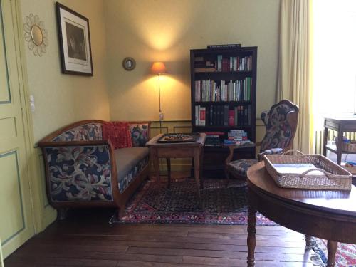 a living room with a couch and a table at Château de Pintray in Lussault-sur-Loire