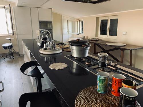 a kitchen with a counter with a stove top oven at COCCO HOUSE in Rocca San Giovanni