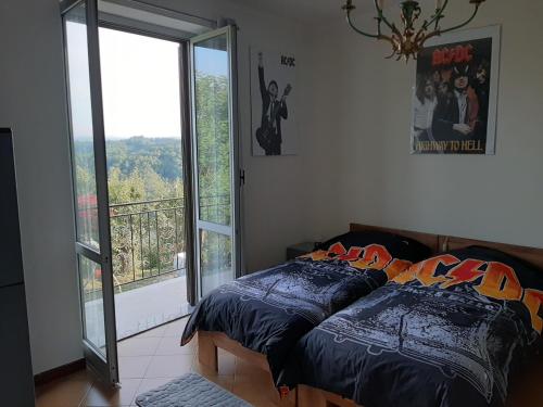 a bedroom with a bed and a sliding glass door at Moto Pareto B&B in Pareto