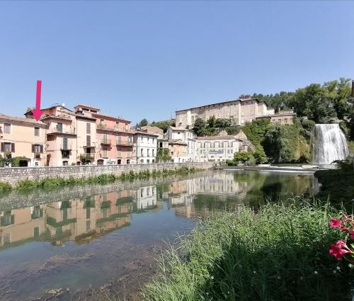 a view of a river with a waterfall and buildings at La finestra sulla cascata in Isola del Liri