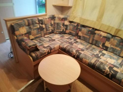 a couch with a table and a small table at CARAVANAS in Orşova
