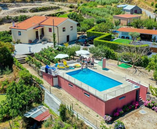 an aerial view of a house with a swimming pool at Quinta da Gandarela in Tarouca