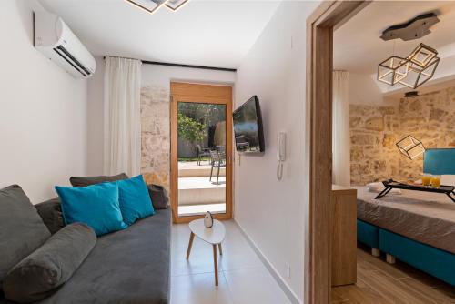 a living room with a couch and a table at Erotokritos City Luxury Suites in Rethymno Town